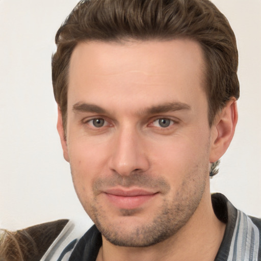 Joyful white young-adult male with short  brown hair and brown eyes