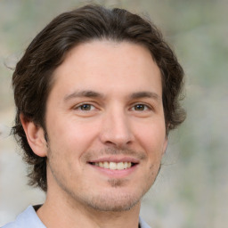 Joyful white young-adult male with medium  brown hair and brown eyes