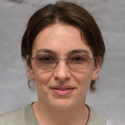 Joyful white adult female with medium  brown hair and brown eyes