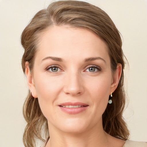 Joyful white young-adult female with medium  brown hair and green eyes