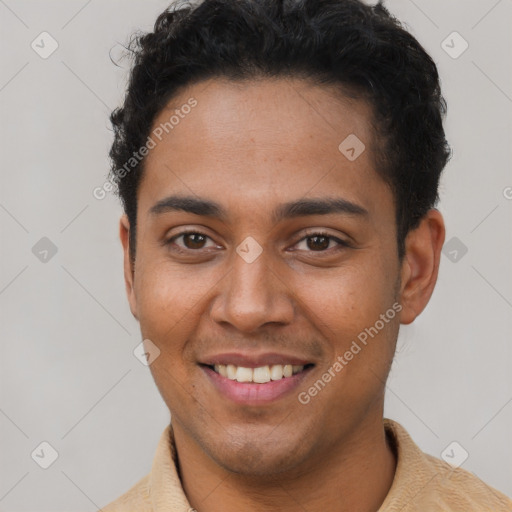 Joyful latino young-adult male with short  brown hair and brown eyes