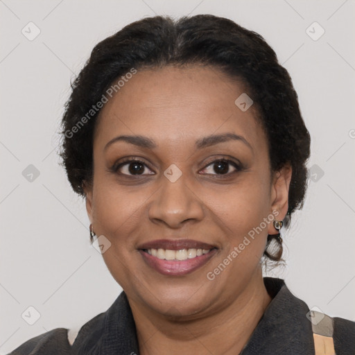 Joyful black adult female with medium  brown hair and brown eyes