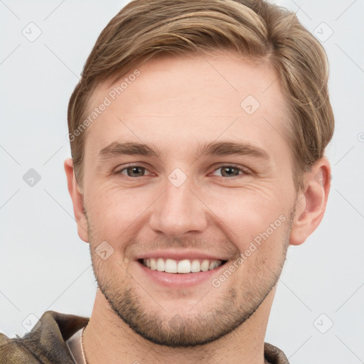 Joyful white young-adult male with short  brown hair and grey eyes