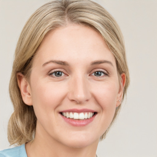 Joyful white young-adult female with medium  brown hair and blue eyes