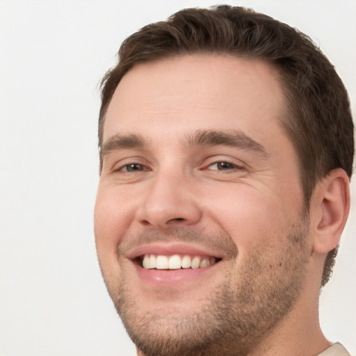 Joyful white young-adult male with short  brown hair and brown eyes