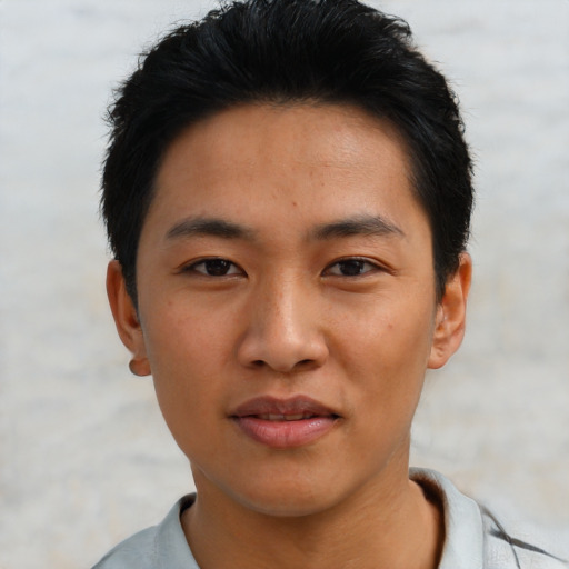 Joyful asian young-adult male with short  black hair and brown eyes