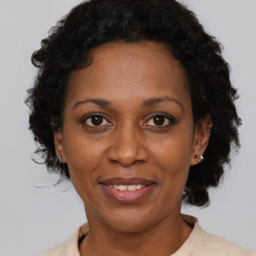 Joyful black adult female with short  brown hair and brown eyes
