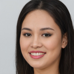 Joyful asian young-adult female with long  brown hair and brown eyes