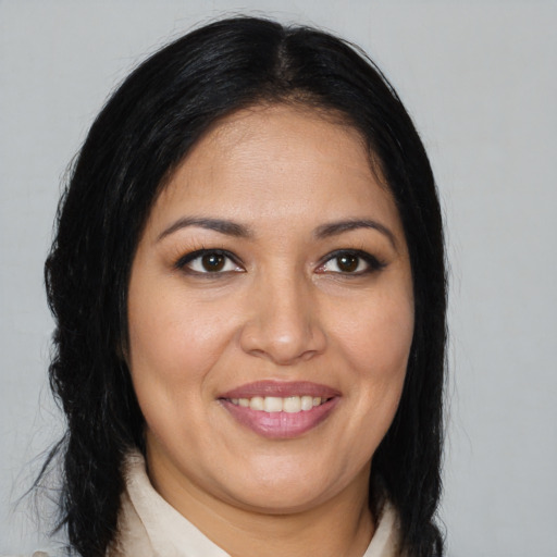 Joyful latino young-adult female with medium  brown hair and brown eyes