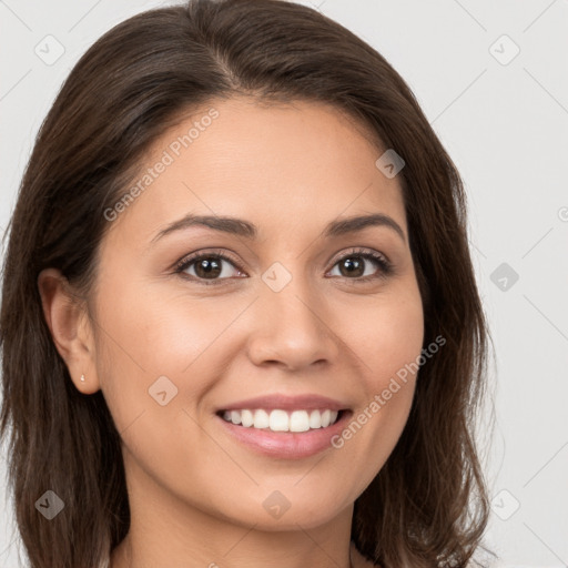 Joyful white young-adult female with long  brown hair and brown eyes