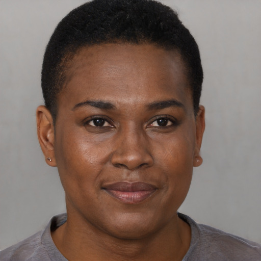 Joyful black young-adult female with short  brown hair and brown eyes
