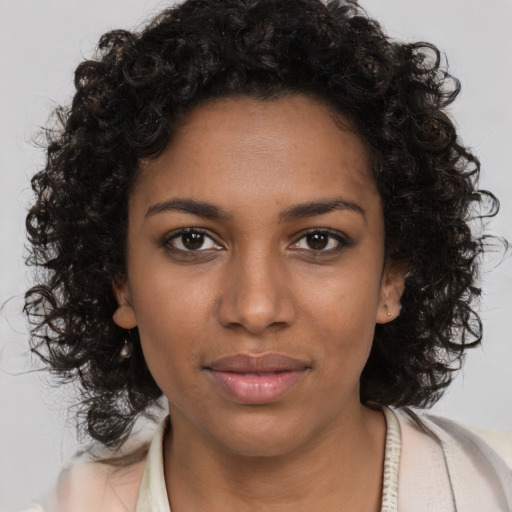 Joyful black young-adult female with medium  brown hair and brown eyes