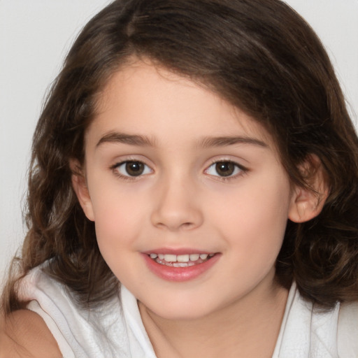 Joyful white child female with medium  brown hair and brown eyes