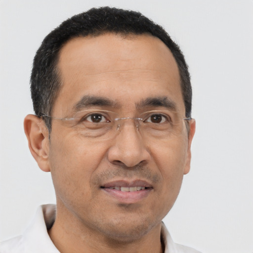 Joyful latino adult male with short  black hair and brown eyes