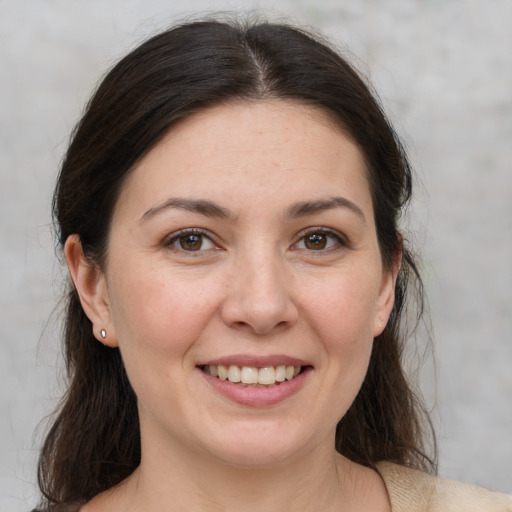 Joyful white young-adult female with medium  brown hair and brown eyes