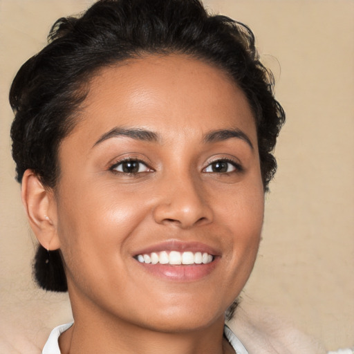 Joyful latino young-adult female with short  brown hair and brown eyes