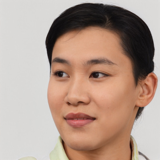 Joyful asian young-adult female with short  black hair and brown eyes