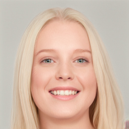 Joyful white young-adult female with long  blond hair and blue eyes