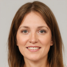 Joyful white young-adult female with long  brown hair and grey eyes