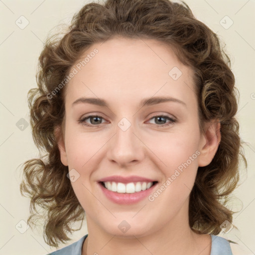 Joyful white young-adult female with medium  brown hair and green eyes