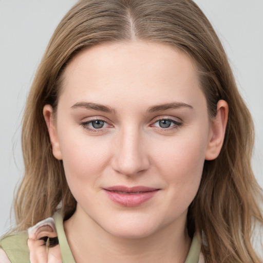 Joyful white young-adult female with long  brown hair and blue eyes