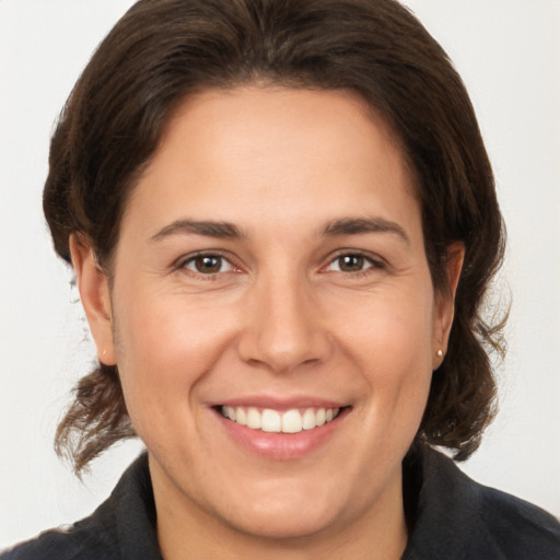 Joyful white adult female with medium  brown hair and brown eyes