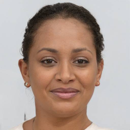 Joyful latino young-adult female with short  brown hair and brown eyes