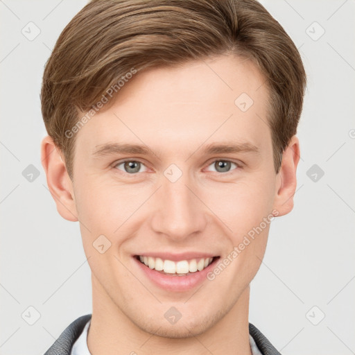 Joyful white young-adult male with short  brown hair and grey eyes