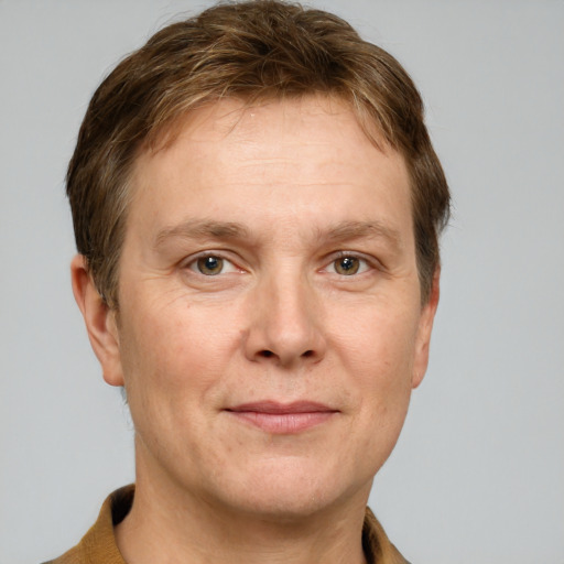 Joyful white adult male with short  brown hair and grey eyes