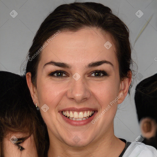 Joyful white young-adult female with medium  brown hair and green eyes