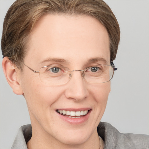 Joyful white adult female with short  brown hair and grey eyes