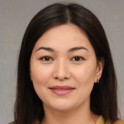 Joyful asian young-adult female with medium  brown hair and brown eyes