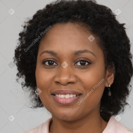 Joyful black young-adult female with long  black hair and brown eyes