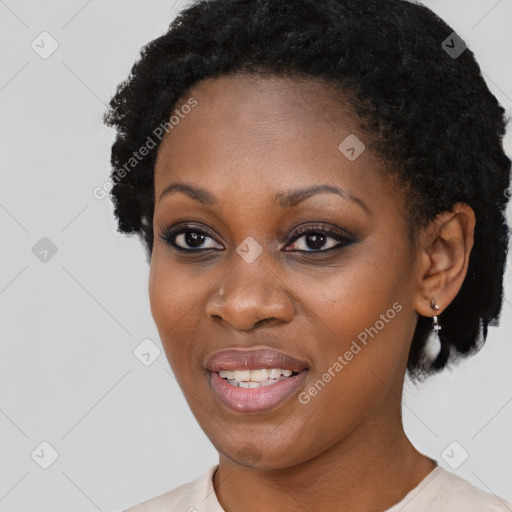 Joyful black young-adult female with short  black hair and brown eyes