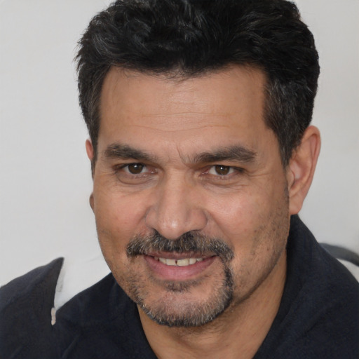 Joyful white adult male with short  black hair and brown eyes