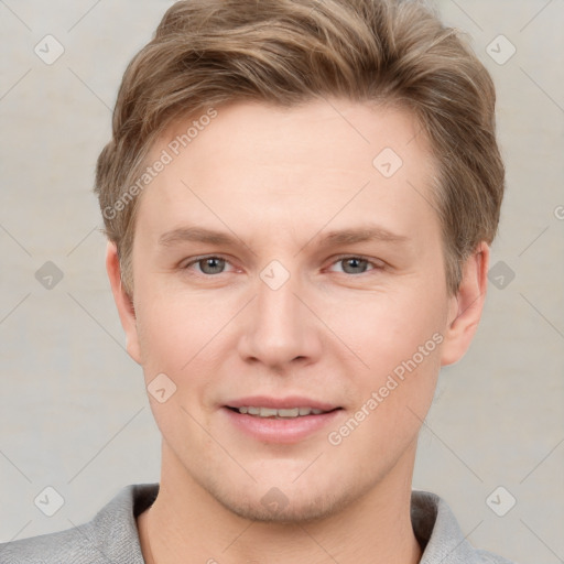 Joyful white young-adult male with short  brown hair and grey eyes