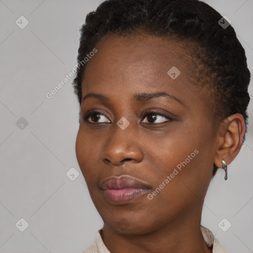 Joyful black young-adult female with short  brown hair and brown eyes