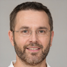 Joyful white adult male with short  brown hair and brown eyes