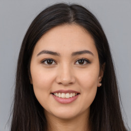 Joyful white young-adult female with long  brown hair and brown eyes