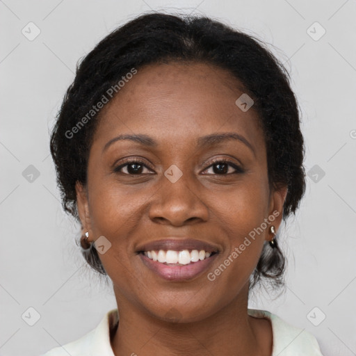 Joyful black adult female with medium  brown hair and brown eyes