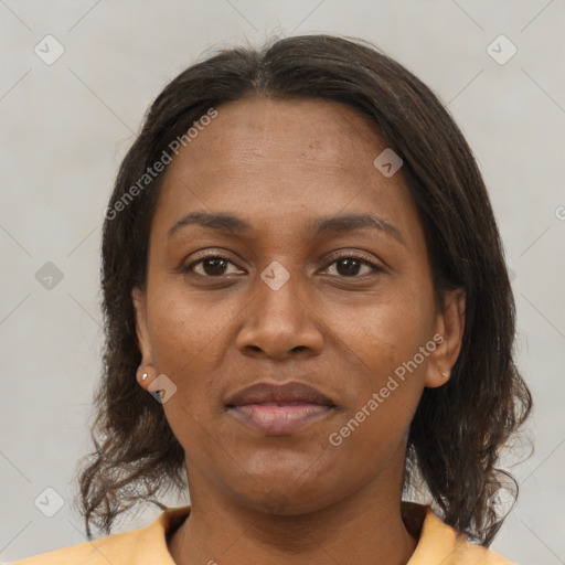 Joyful latino adult female with medium  brown hair and brown eyes