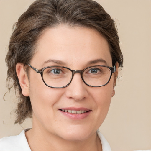 Joyful white adult female with short  brown hair and brown eyes