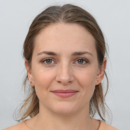 Joyful white young-adult female with medium  brown hair and grey eyes