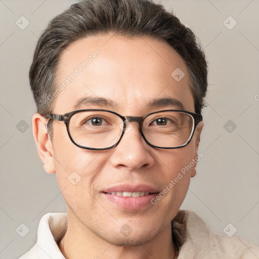 Joyful white adult male with short  brown hair and brown eyes