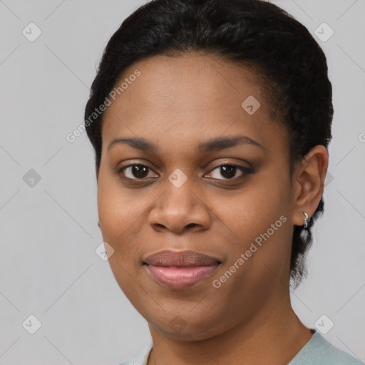 Joyful black young-adult female with short  black hair and brown eyes