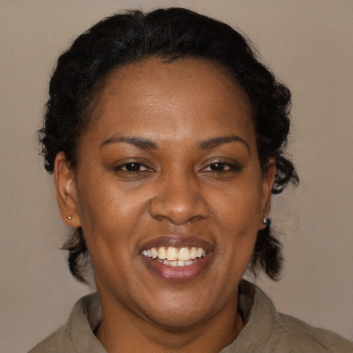 Joyful black adult female with medium  black hair and brown eyes