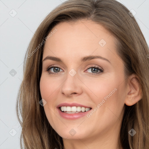 Joyful white young-adult female with long  brown hair and grey eyes