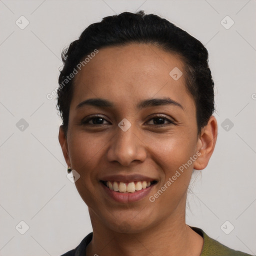 Joyful latino young-adult female with short  black hair and brown eyes