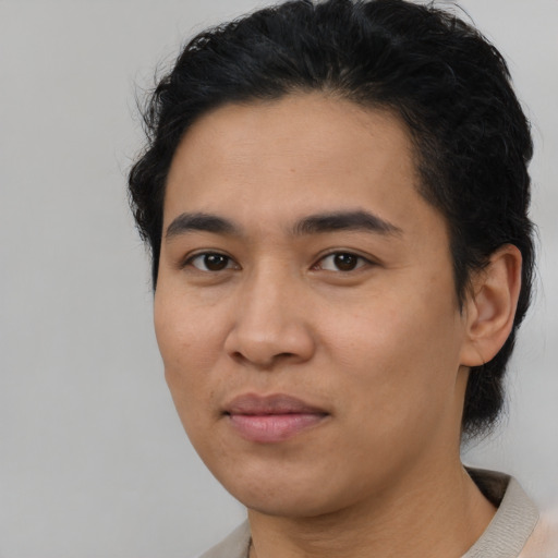 Joyful asian young-adult male with short  brown hair and brown eyes