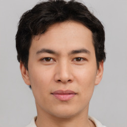 Joyful asian young-adult male with short  brown hair and brown eyes